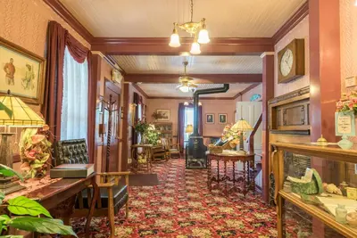 a hallway with a room with chairs and tables at Julian Gold Rush Hotel in Julian