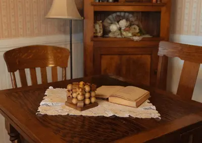 a wooden table with an open book and a book at Julian Gold Rush Hotel in Julian
