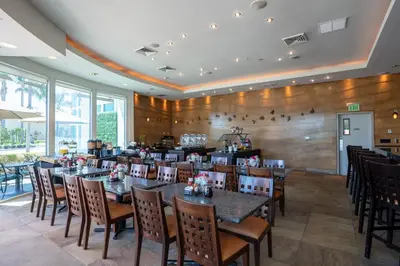a dining room with tables and chairs in a restaurant at The Dana on Mission Bay in San Diego