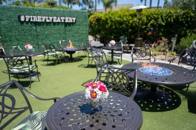 a group of tables and chairs with flowers on them at The Dana on Mission Bay in San Diego