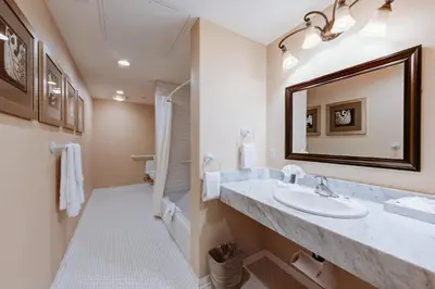 a bathroom with a sink and a mirror at Gaslamp Plaza Suites in San Diego