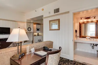 a living room with a couch and a table at Gaslamp Plaza Suites in San Diego