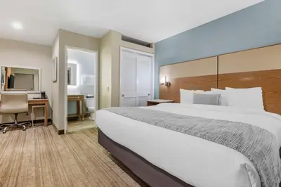 a hotel room with a large bed and a desk at Best Western Carlsbad by the Sea in Carlsbad