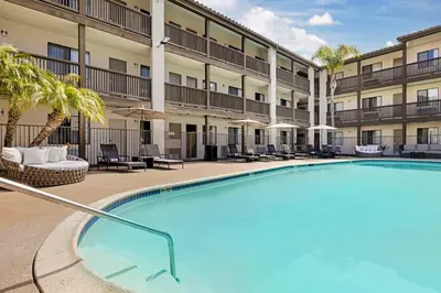 a swimming pool at a hotel with a resort at Best Western Carlsbad by the Sea in Carlsbad