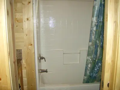 a shower in a bathroom with a white tub at Pio Pico Camping Resort Cottage 1 in Jamul