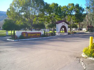 a building with a sign in the middle of a street at Pio Pico Camping Resort Cottage 1 in Jamul