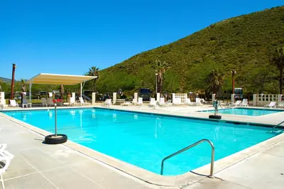 a large swimming pool with a mountain in the background at Pio Pico Camping Resort Studio Cabin 10 in Jamul