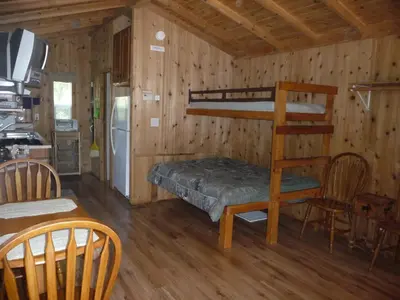 a room with a bunk bed and a kitchen at Pio Pico Camping Resort Studio Cabin 10 in Jamul