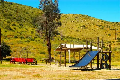 a playground with a slide and a slideintend at Pio Pico Camping Resort One-Bedroom Cabin 13 in Jamul