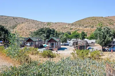 a view of a campground with mountains in the background at Pio Pico Camping Resort One-Bedroom Cabin 14 in Jamul