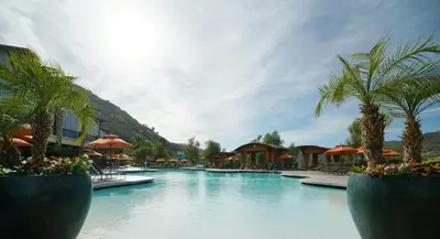 a swimming pool with palm trees and umbrellas at a resort at Hyatt Vacation Club at the Welk, San Diego in Escondido