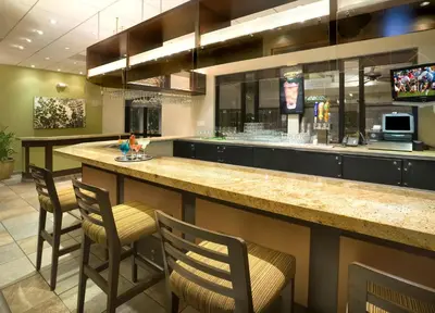a bar in a restaurant with chairs and a counter at Hyatt Vacation Club at the Welk, San Diego in Escondido