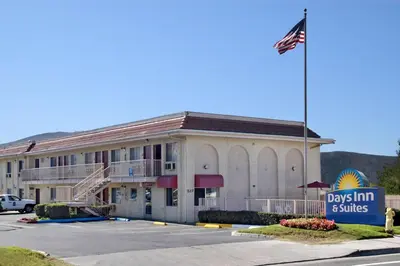 a hotel with a flag in front of a building at Days Inn by Wyndham San Marcos in San Marcos
