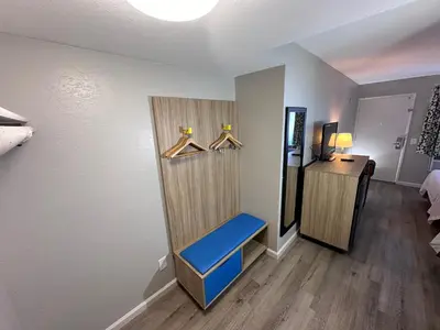 a room with a room with a blue bench in it at Days Inn by Wyndham San Marcos in San Marcos