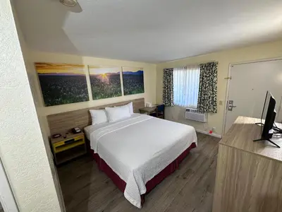 a hotel room with a bed and a flat screen tv at Days Inn by Wyndham San Marcos in San Marcos