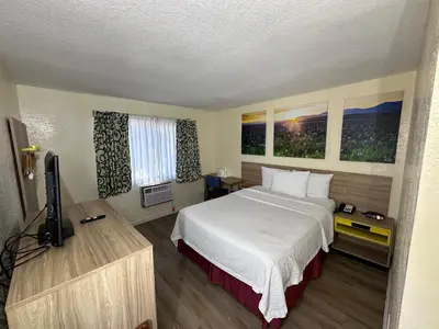 a hotel room with a bed and a television at Days Inn by Wyndham San Marcos in San Marcos