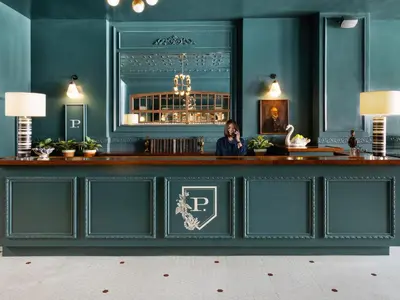a woman sitting at a bar talking on a cell phone at Palihotel San Diego Gaslamp Quarter in San Diego