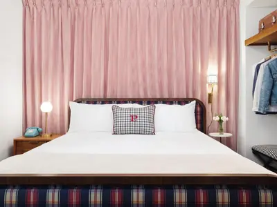 a bedroom with a bed and pink curtains at Palihotel San Diego Gaslamp Quarter in San Diego