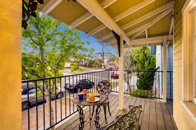 a patio with a table and chairs on a balcony at Casa California - Backyard, BBQ, Firepit & Near Beaches in San Diego