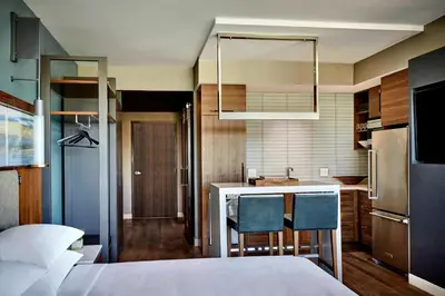 a room with a kitchen with a bed and a kitchen at Marriott Irvine Spectrum in Irvine