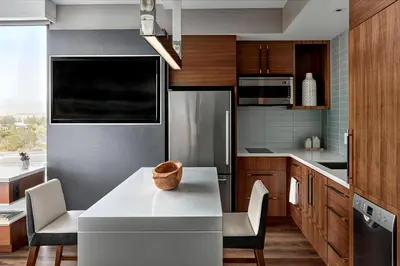 a kitchen with a white table and chairs in it at Marriott Irvine Spectrum in Irvine