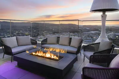 a living room with a fire pit on top of a building at Marriott Irvine Spectrum in Irvine