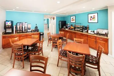 a restaurant with tables and chairs and a counter at Signature Temecula in Temecula