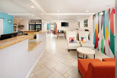 a lobby of a salon with orange chairs at Signature Temecula in Temecula