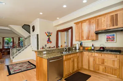 a kitchen with wooden cabinets and a sink at Holiday Home in Oceanside