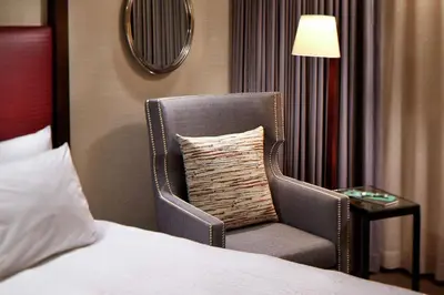 a chair sitting next to a bed in a hotel room at Hilton Garden Inn San Diego Old Town/Sea World Area in San Diego