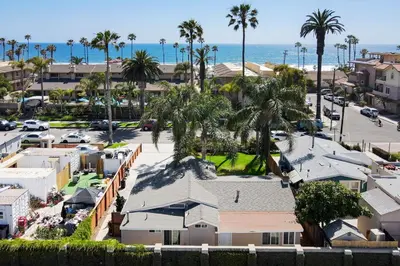 an aerial view of a resort with palm trees and the ocean at Oceanside Rocks Family Vacation Home in Oceanside