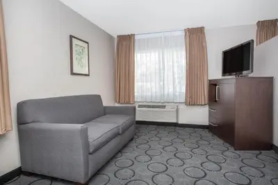 a living room with a couch and a television at Baymont by Wyndham San Diego Downtown in San Diego