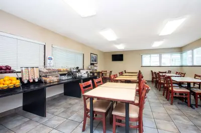 a dining room with tables and chairs in a restaurant at Baymont by Wyndham San Diego Downtown in San Diego