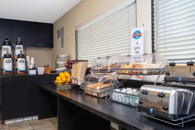 a kitchen with a counter with food and drinks at Baymont by Wyndham San Diego Downtown in San Diego
