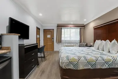 a hotel room with a bed and a flat screen tv at Motel 6 Carlsbad, Ca- North in Carlsbad