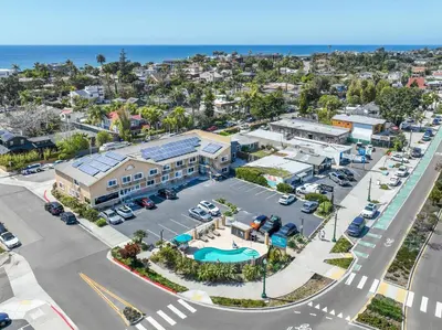 an aerial view of a parking lot in front of the ocean at Brisa Pacific Hotel Encinitas in Encinitas