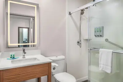 a bathroom with a toilet and a sink and a shower at Brisa Pacific Hotel Encinitas in Encinitas