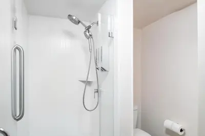 a bathroom with a shower with a shower head at Brisa Pacific Hotel Encinitas in Encinitas