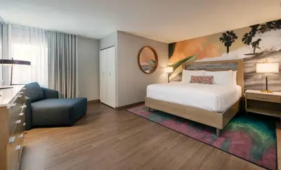 a hotel room with a bed and a chair at The Wayfarer San Diego in San Diego