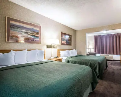 a hotel room with two beds and a window at Quality Suites San Diego Otay Mesa in Otay Mesa