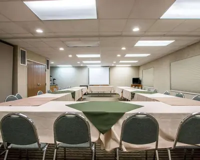 a conference room with tables and chairs and a whiteboard at Quality Suites San Diego Otay Mesa in Otay Mesa