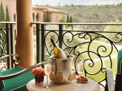 a table with wine glasses and a pear in a bucket on a balcony at Fairmont Grand Del Mar in San Diego