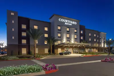 a building with a car parked in front of it at Courtyard by Marriott San Diego El Cajon in El Cajon