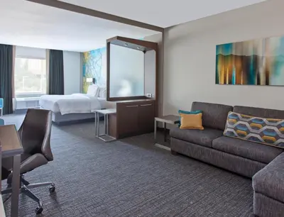 a hotel room with a couch and a bed at Courtyard by Marriott San Diego El Cajon in El Cajon