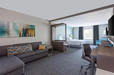 a living room with a couch and a bedroom at Courtyard by Marriott San Diego El Cajon in El Cajon