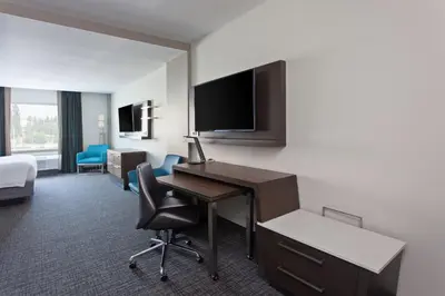 a hotel room with a desk and a bed at Courtyard by Marriott San Diego El Cajon in El Cajon
