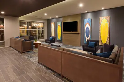 a waiting room with couches and a flat screen tv at Courtyard by Marriott San Diego El Cajon in El Cajon