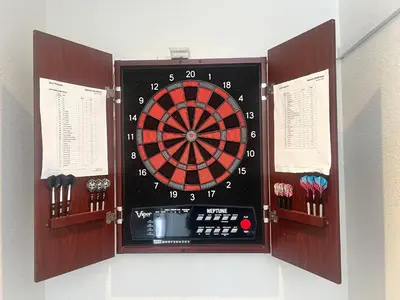 a dart board with a dartboard in a wall at Sweet Beach Duplex in Newport Beach