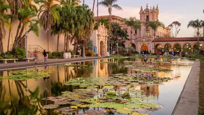 a garden with lily pads in a pond in front of a building at Studio 6 Suites San Ysidro CA San Diego South Bay in San Ysidro, San Diego