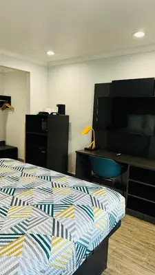 a bedroom with a bed and a desk and a tv at Studio 6 Suites San Ysidro CA San Diego South Bay in San Ysidro, San Diego
